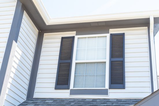 white siding with dark gray shutters close up