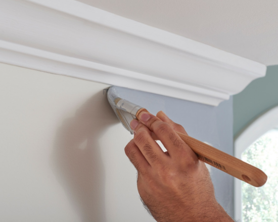closeup photo of painter painting interior wall