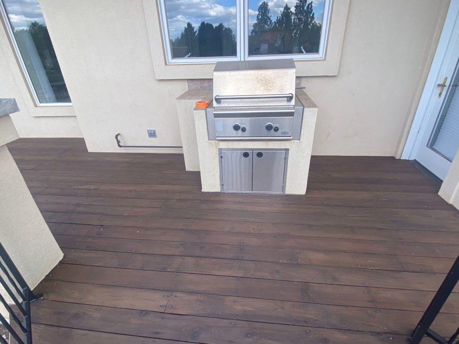 propane grill on stained wooden deck Preview Image 6