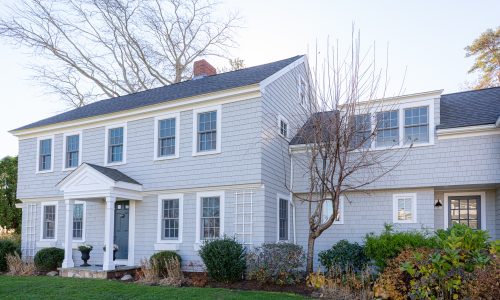 Front of cedar shingle home after staining and painting project.
