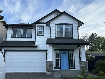 house exterior with white painted siding and black trim with blue door
