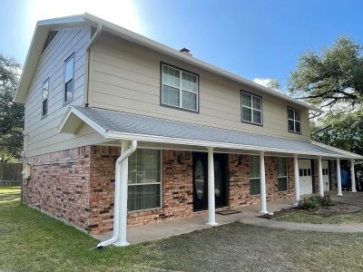 house exterior with brick and painted cream siding