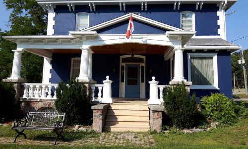 Navy Two-Story Exterior Repaint with White Architectural Millwork