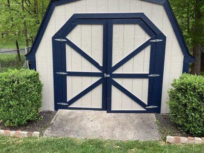 white shed with black handles and accents