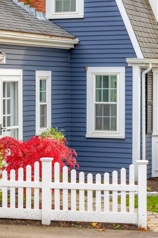 white fence and blue and white painted home