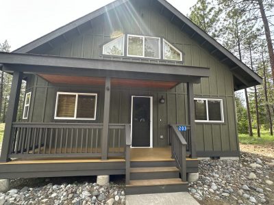 dark green stained cabin home exterior