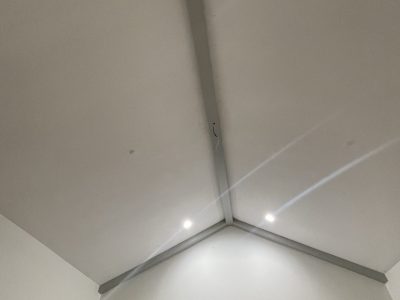 grey painted beam on white residential ceiling