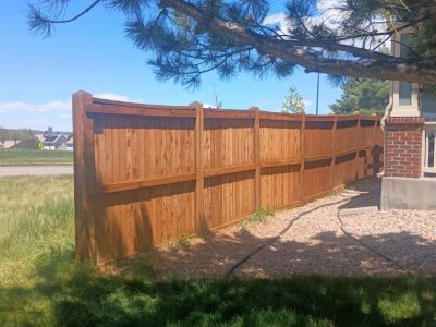stained wooden fence surrounding yard