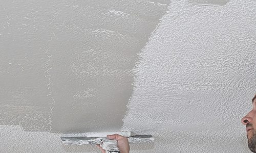 Skim coating being applied