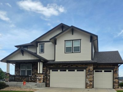After exterior color change showing the front exterior and garage of a Castle Rock home