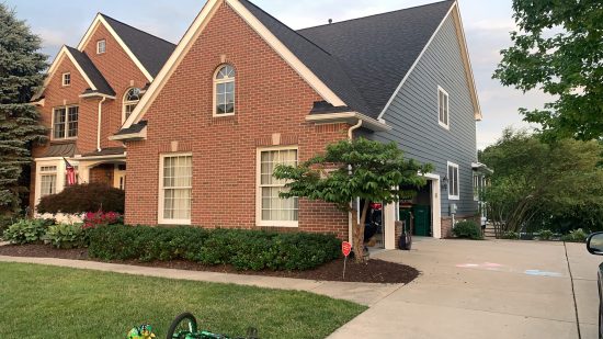 This home is a mixture of Brick and natural wood siding, soffits, and fascia was repainted by CertaPro.