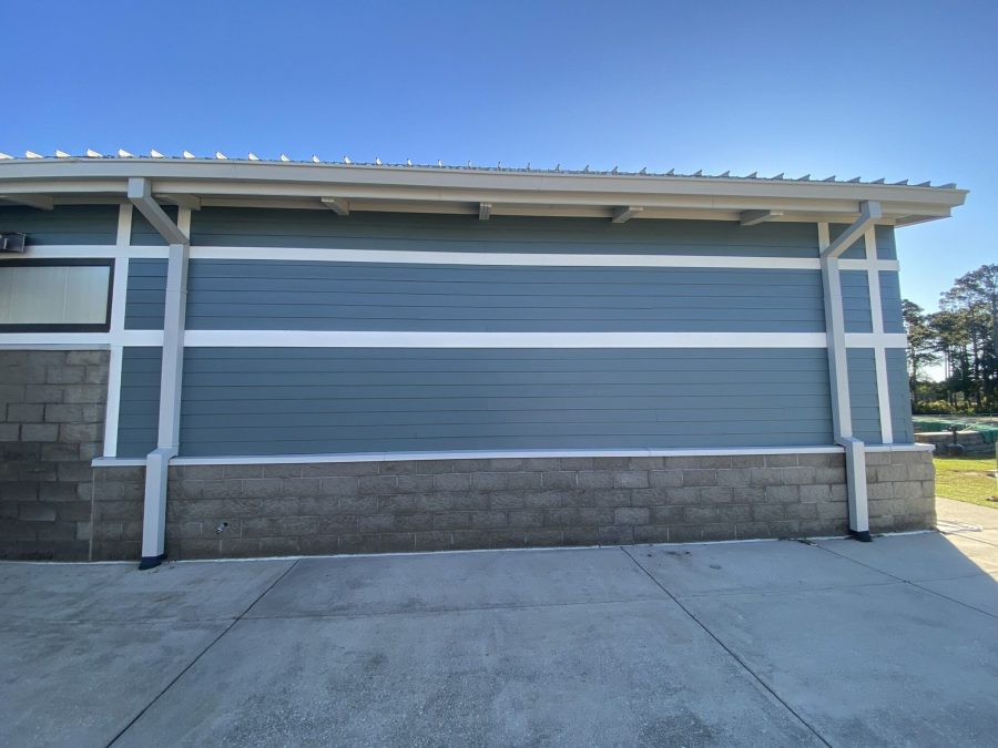 close up view of siding of freshly painted blue commercial building Preview Image 6