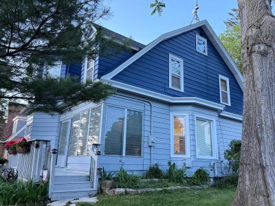 painted house exterior with navy and grey siding