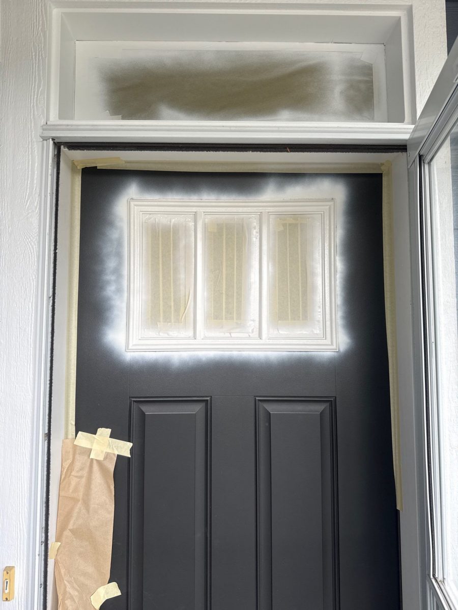 front door with protective covering during paint primer application Preview Image 3
