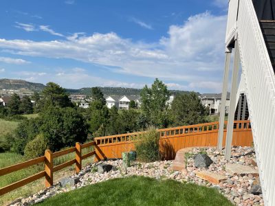 stained fence surrounding house and yard