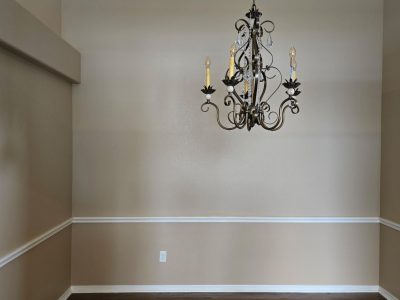 painted interior room with wood floor and chair rail trim