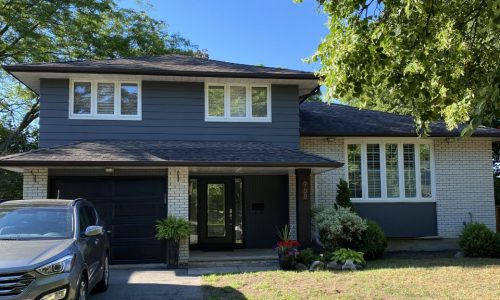 Deep Navy Siding, Overhead Door, and Bright White Trim Repaint