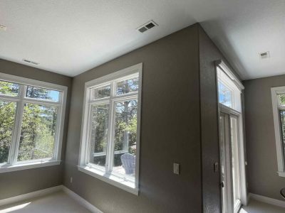 room with large windows and painted wall