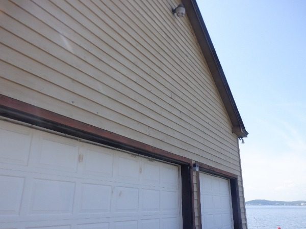 Right side of a Dadeville lake house before exterior painting with aged siding Preview Image 9