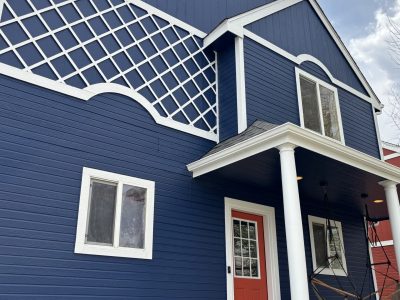 blue painted house with white trim and red door