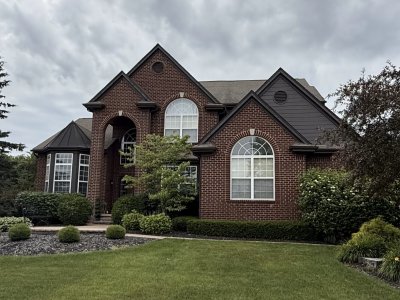 front of brick house with grey siding