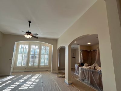 living room with protective sheeting for painting