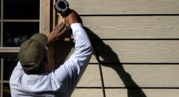 working on siding exterior