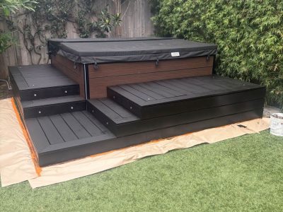 backyard hot tub with painted deck