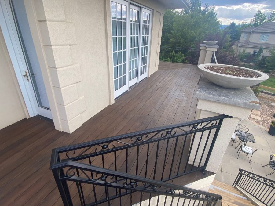 stained wooden deck against house with black metal railing Preview Image 7