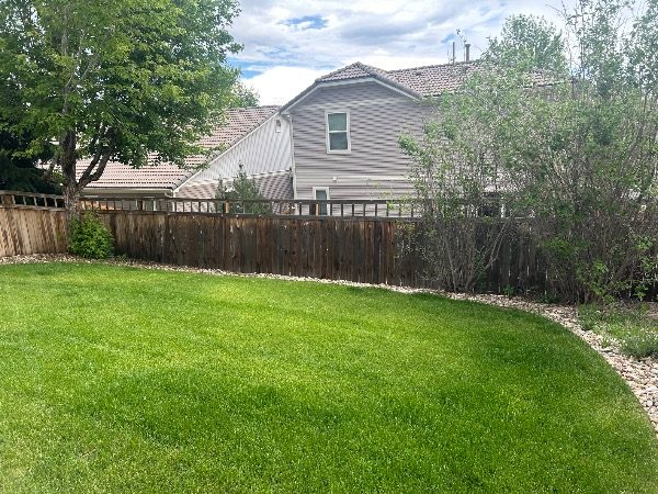 unstained fence surrounding home and yard Preview Image 6