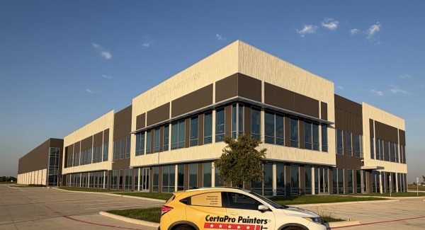 Black cohesive campus aesthetic building with white wall accents in Houston, TX. A CertaPro Painter wrapped car is parked in front of the building.