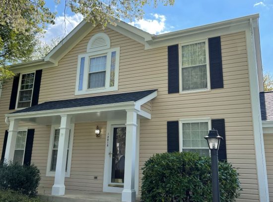 tan home with black shutters