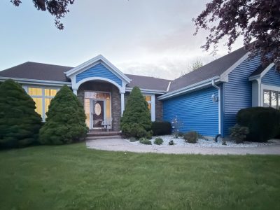 blue painted home exterior with white trim and window frames