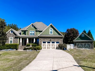 large home with a long driveway after exterior painting