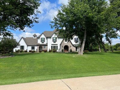 home exterior after repaint with white stucco and grey accents