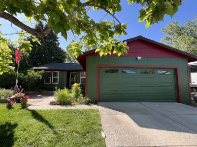 front of house with green siding and red trim
