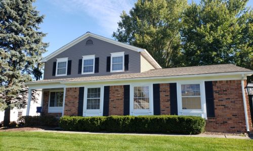 And a medium brick and siding house