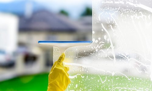 yellow glove cleaning window