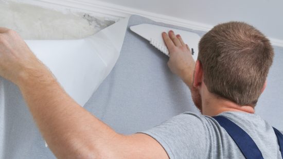 Wallpaper installation services man installing wallpaper