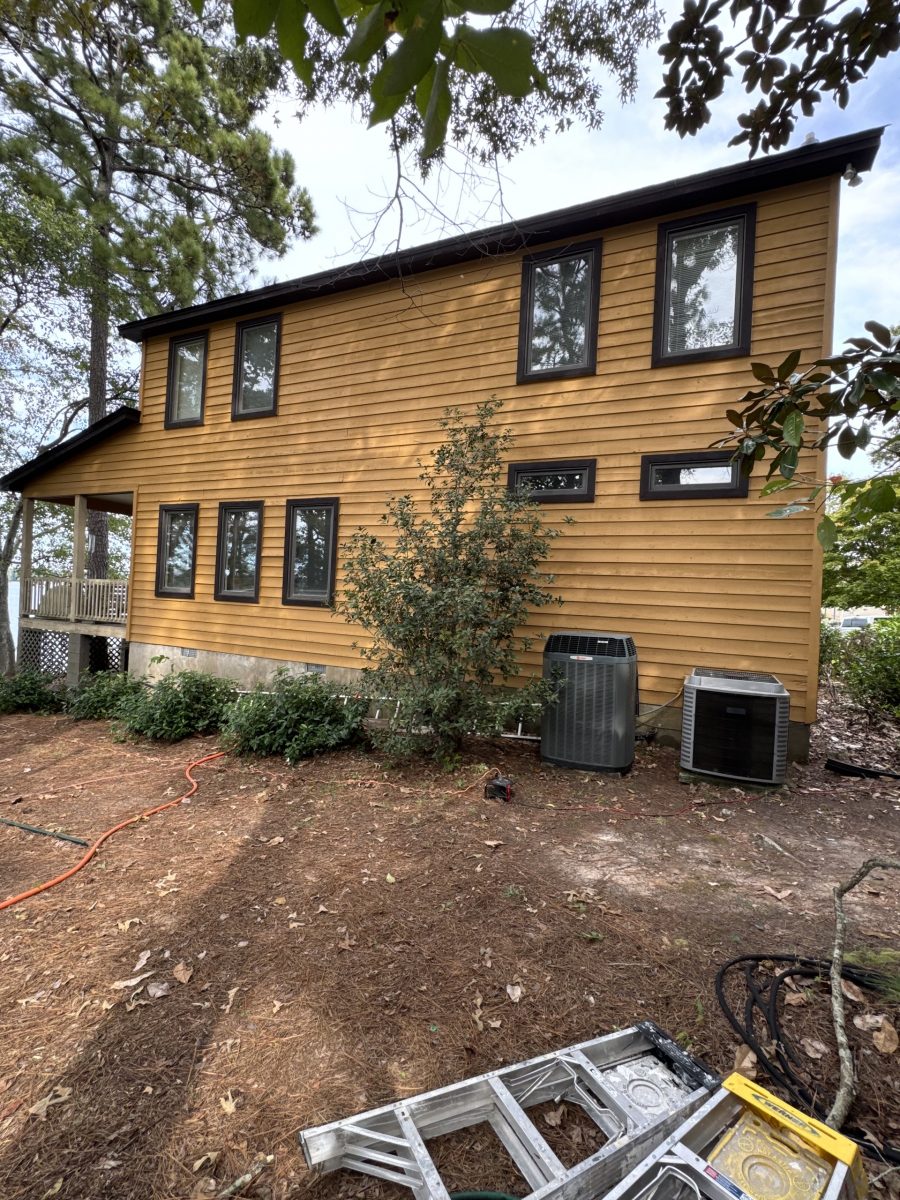 Left elevation of a Dadeville lake house after exterior painting with updated siding color and dark trim Preview Image 2