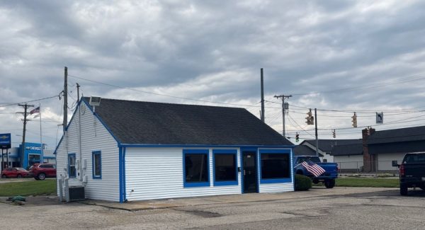 sales office exterior with white painted siding and blue trim