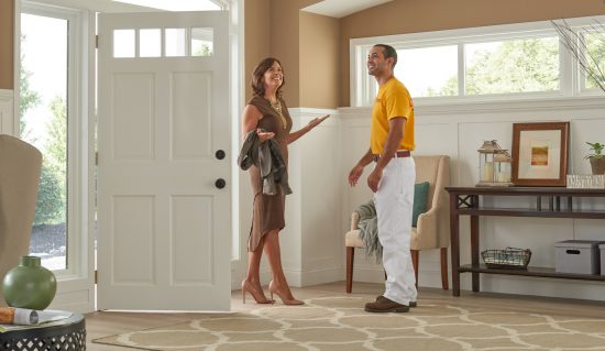 customer and painter looking at house