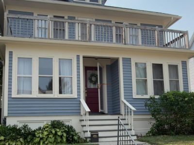 soft blue painted wood siding and off white trim home exterior