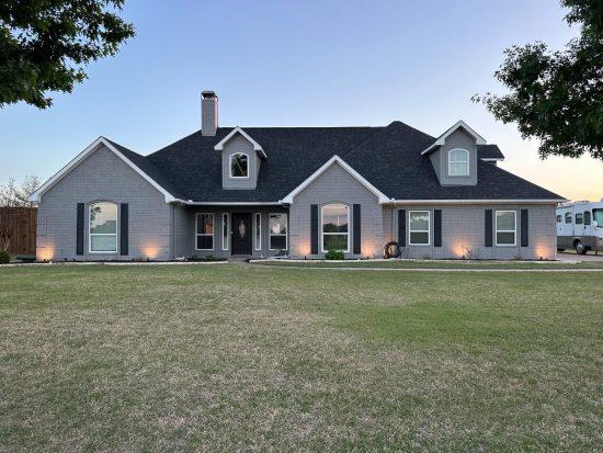 A beautiful brick home with a fresh coat of grey paint