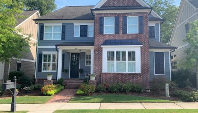 brick and siding colonial home painted blue and white by marietta exterior painters