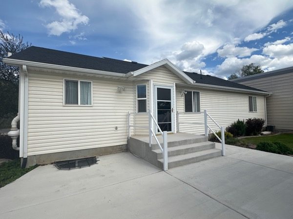 house exterior with off-white vinyl siding before repaint Preview Image 6