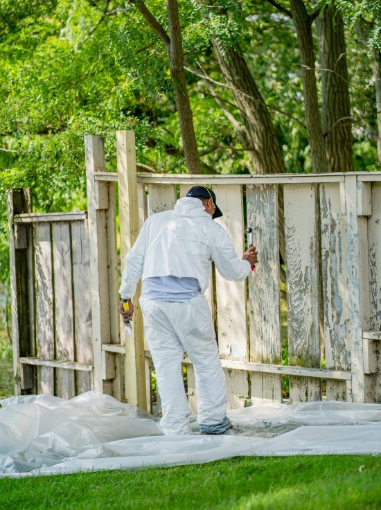 CertaPro Crew member restoring a fence