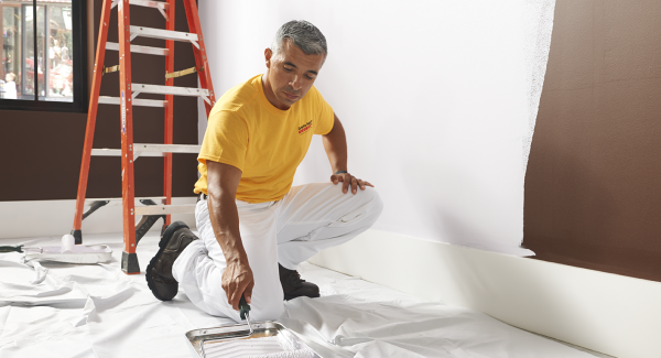 interior house painters with a roller and paint tray.