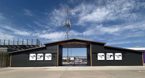 barn style stadium entrance painted black with yellow trim