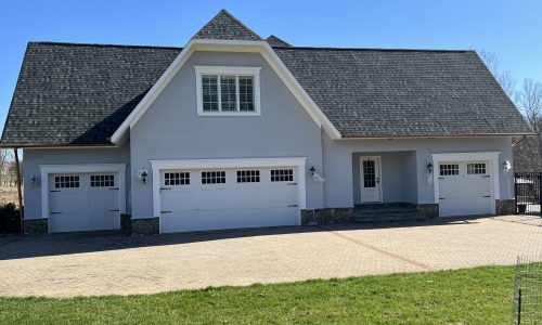 Exterior Stucco Wall Coating and Carriage-Style Garage Door Painting